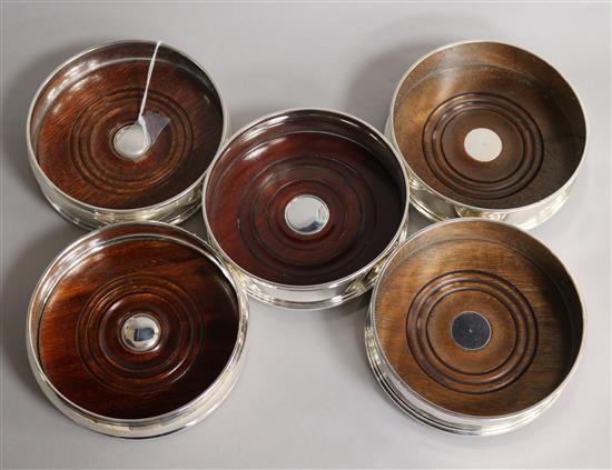 Two pairs of modern silver mounted wine coasters and a single silver mounted wine coaster.